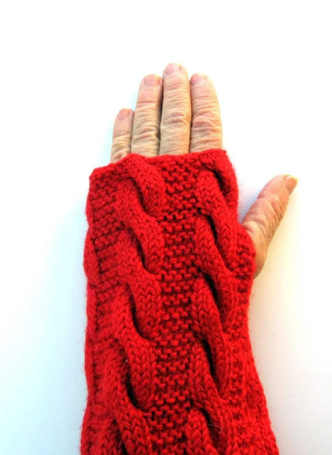 Knitted red set: a pom-pom cap and fingerless gloves/gaiters