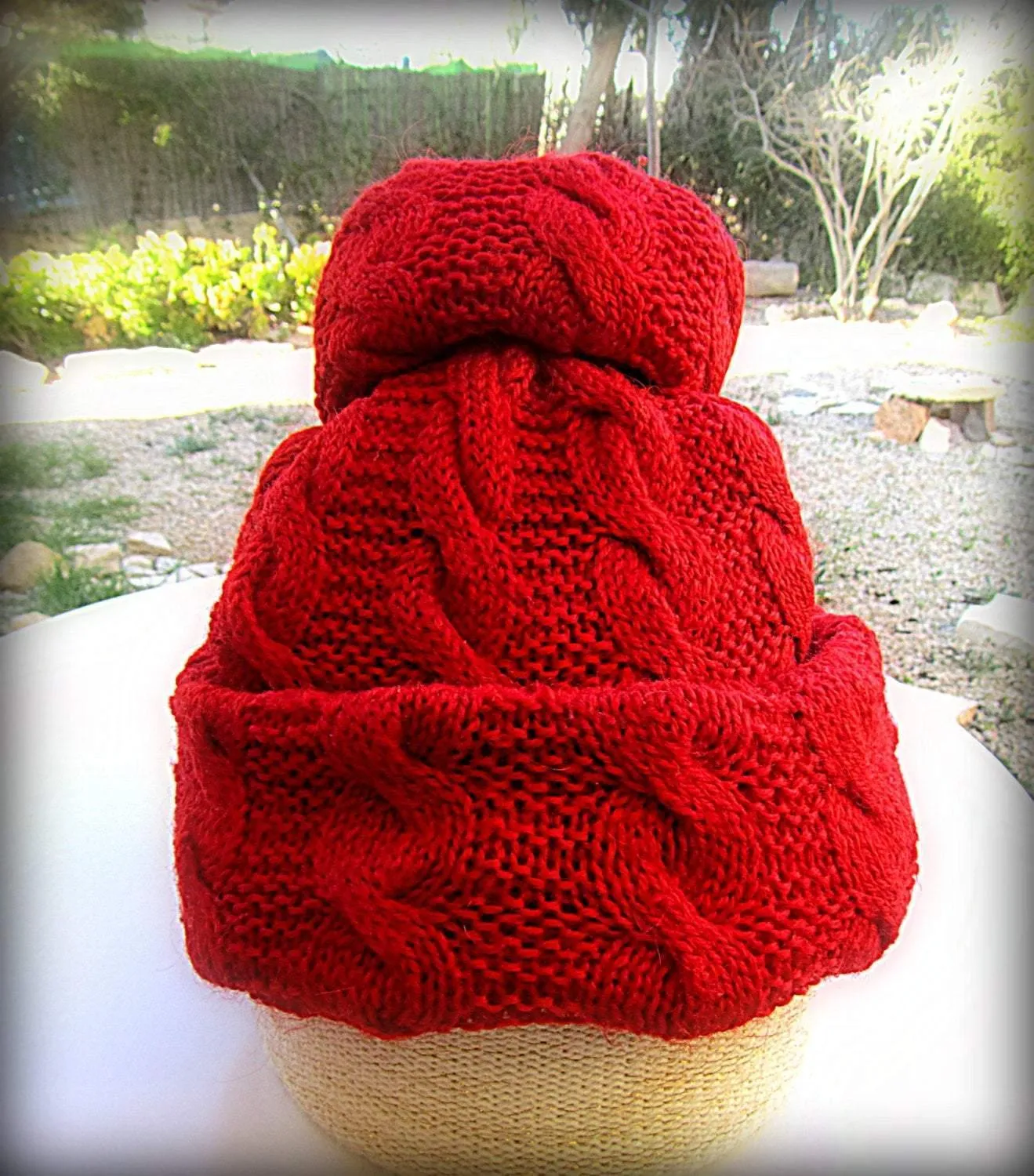 Knitted red set: a pom-pom cap and fingerless gloves/gaiters